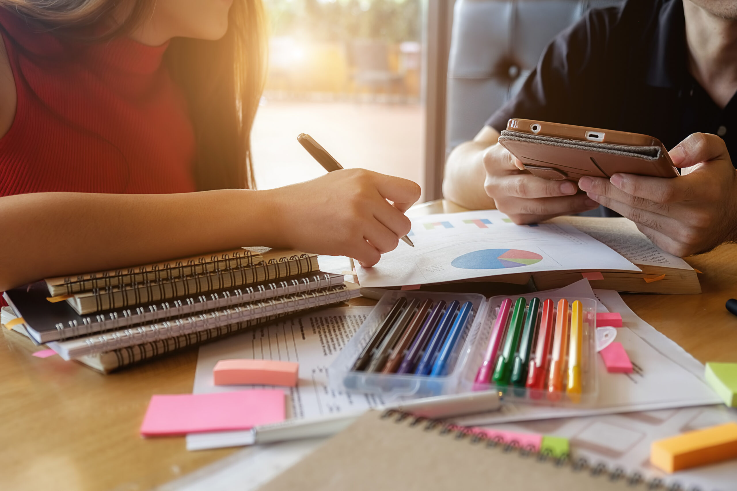 Education concept. Student studying and brainstorming campus concept. Close up of students discussing their subject on books or textbooks. Selective focus.